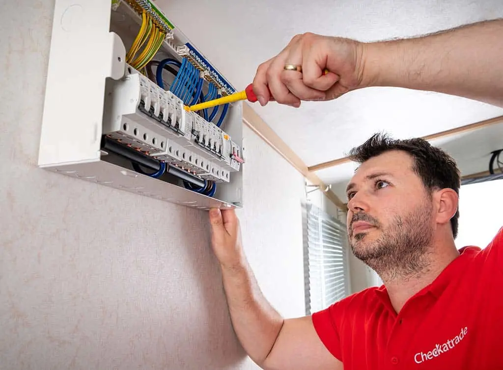 Electrician testing a consumer unit with professional equipment